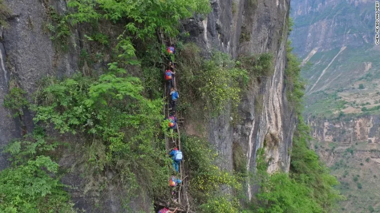 children climbing cliff